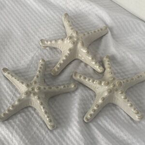 HD Designs Ceramic Knobby Starfish Decor Set of Three. Each Starfish is 5”